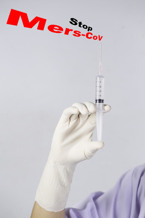 holding syringe inject Stop MERS-CoV textの写真素材