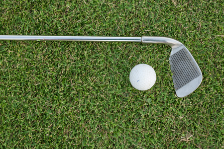 Golf club and ball in grassの写真素材