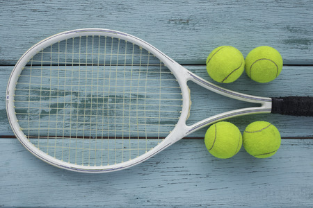 Close up view of tennis racket and balls on the wooden tableの写真素材