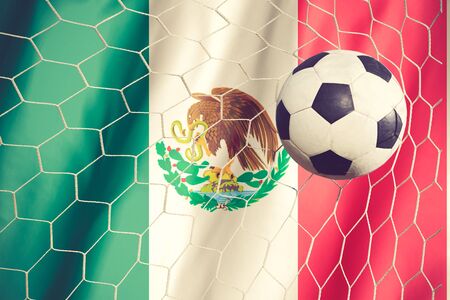 Ball streaks across the flag of Mexico, where soccer is a national passion.vintage colorの写真素材