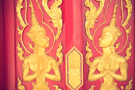The ramayana epic carved on a wood door inside a temple.They are public domain or treasure of Buddhism, no restrict in copy or use vintage colorのeditorial素材