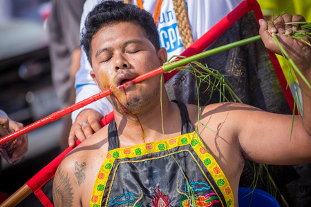 Nakhon Ratchasima, THAILAND - OCT 16: An unidentified devotee of Vegetarian Festival, person who invites the spirits of gods to possess their bodies on October 16, 2015 in Nakhon Ratchasima, Thailandのeditorial素材