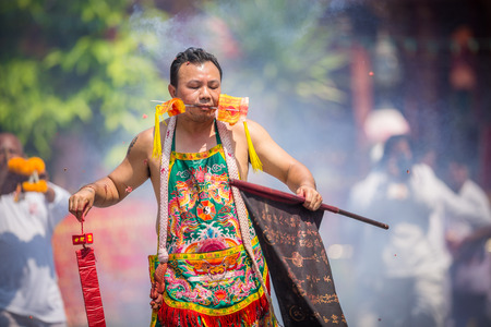Nakhon Ratchasima, THAILAND - OCT 16: An unidentified devotee of Vegetarian Festival, person who invites the spirits of gods to possess their bodies on October 16, 2015 in Nakhon Ratchasima, Thailandのeditorial素材