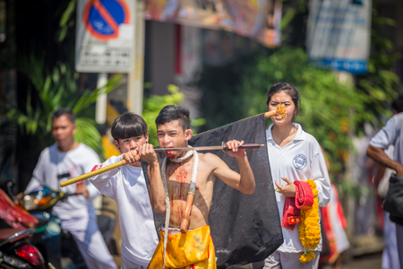 Nakhon Ratchasima, THAILAND - OCT 16: An unidentified devotee of Vegetarian Festival, person who invites the spirits of gods to possess their bodies on October 16, 2015 in Nakhon Ratchasima, Thailandのeditorial素材