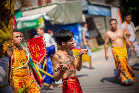 Nakhon Ratchasima, THAILAND - OCT 16: An unidentified devotee of Vegetarian Festival, person who invites the spirits of gods to possess their bodies on October 16, 2015 in Nakhon Ratchasima, Thailandのeditorial素材