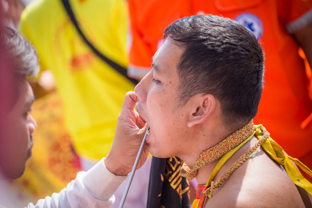 Nakhon Ratchasima, THAILAND - OCT 16: An unidentified devotee of Vegetarian Festival, person who invites the spirits of gods to possess their bodies on October 16, 2015 in Nakhon Ratchasima, Thailandのeditorial素材