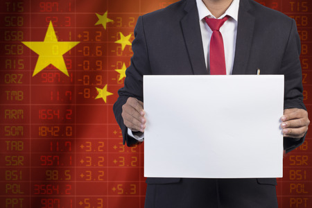 businessman in black suit holding sign empty on Flag of China Business Conceptの写真素材