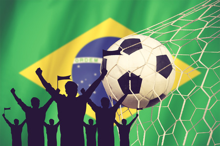 silhouettes of Soccer fans with flag of brazil .Cheer Concept vintage colorの写真素材
