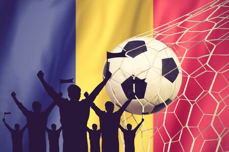 silhouettes of Soccer fans with flag of Romania .Cheer Concept vintage colorの写真素材