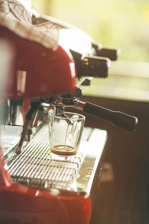 Professional espresso machine pouring strong looking fresh coffee .Vintage colorの写真素材