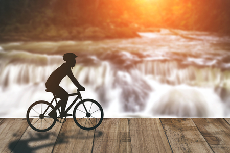 Silhouette of a man on muontain-bike, sunsetの写真素材