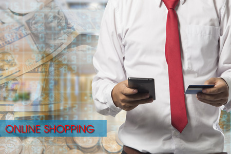 Man holding smart phone and credit card indoor, Shopping Onlineの写真素材