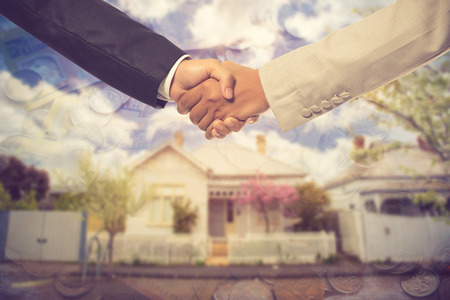 Shaking Hands in Front of a Beautiful New House and Sold For Sale.Vintage colorの写真素材