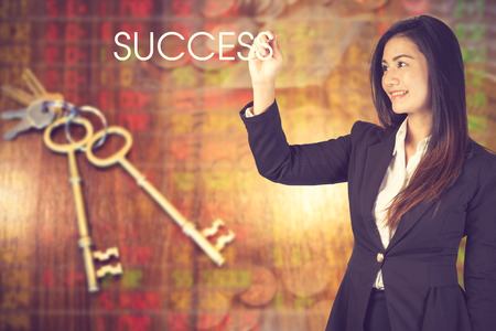 Businesswoman standing with back and making word success.concept of key to success.Vintage colorの写真素材