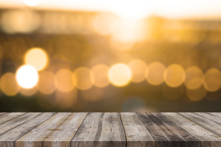 Wood table top on golden bokeh abstract background - can be used for montage or display your productsの写真素材