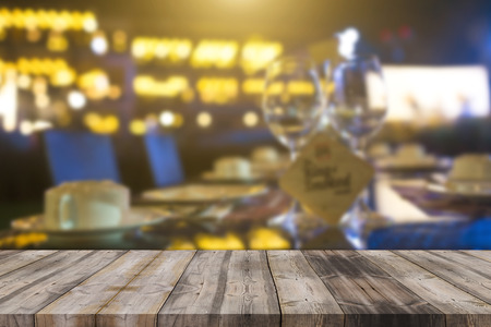 image of wooden table in front of abstract blurred background of resturant lights can be used for...