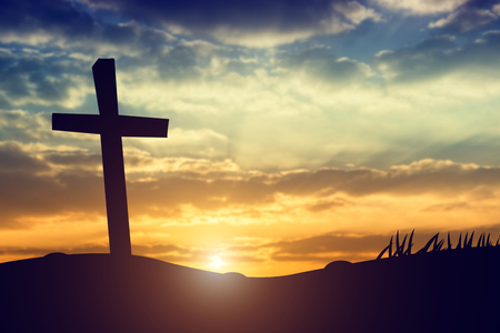 cross silhouette on the mountain at sunsetの写真素材
