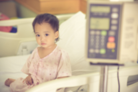 blurred of sick Little girl in hospital bed.for background.Vintage colorの写真素材