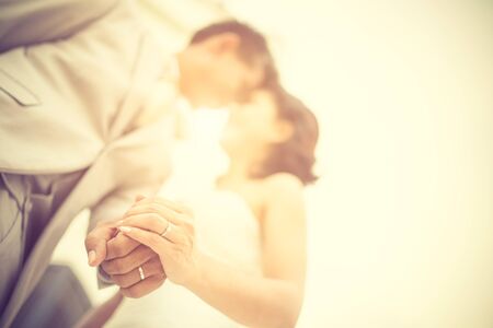 Wedding couple holding hands on sunset background.Soft focus.Vintage colorの写真素材
