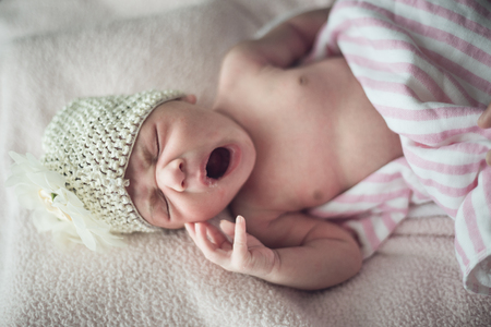 sleeping newborn baby on a blanketの写真素材
