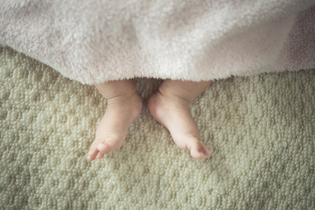 Newborn baby feet.vintage colorの写真素材