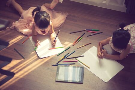 Kids drawing on floor on paper.vintage colorの写真素材
