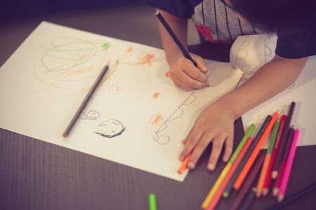 Kids drawing on floor on paper.vintage color