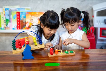 child little girl playing wooden toysの写真素材