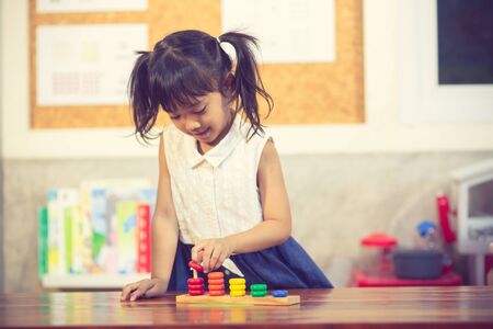 child little girl playing wooden toysの写真素材