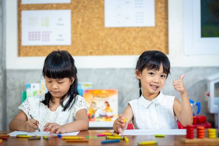 Preschooler child girl drawing and coloringの写真素材