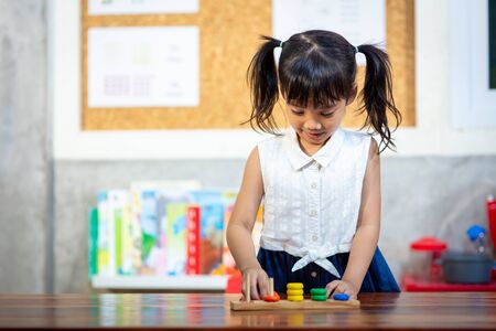 child little girl playing wooden toysの写真素材