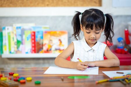 Preschooler child girl drawing and coloringの写真素材