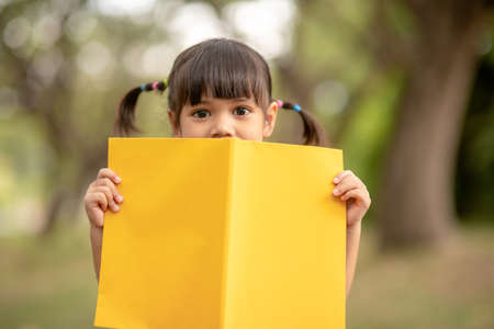 pretty girl The little girl is happy with the bookの写真素材