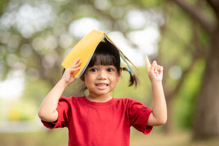 pretty girl The little girl is happy with the bookの写真素材