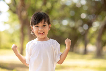 Happy little asian girl having fun at the parkの写真素材
