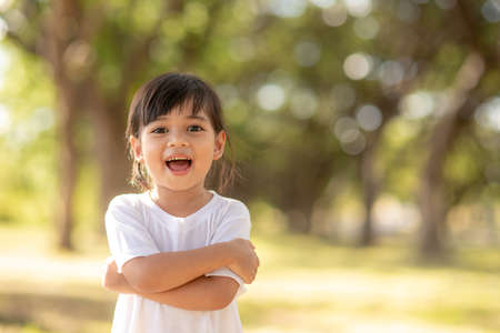 Happy little asian girl having fun at the parkの写真素材