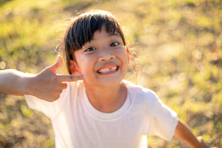 little girl showing her broken milk teethの写真素材