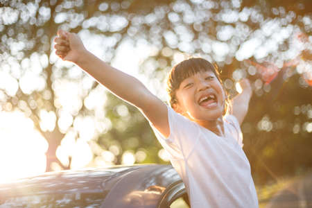 adorable kids on car trip looking out of the car windowの写真素材