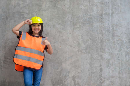 Asian Kid girl wearing reflective shirts and a hat yellow. To learning and enhance development,...