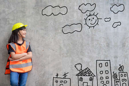 Asian Little girl engineering with creative drawing environment with happy family, against a brick...