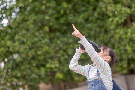 Happy kid looking ahead. Smiling child with the spyglass. Travel and adventure concept. Freedom, vacationの写真素材