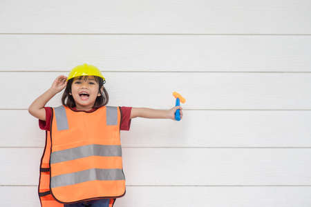 Asian Kid girl wearing reflective shirts and a hat yellow. To learning and enhance development, little architect.の写真素材
