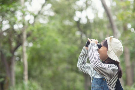 Happy kid looking ahead. Smiling child with the binoculars. Travel and adventure concept. Freedom, vacationの写真素材