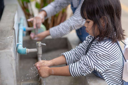 Asian kids are washing their hands. Protection against infections and viruses.の写真素材