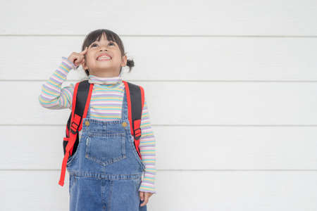 Portrait of Lovely Asian girl thinking on white backgroundの写真素材