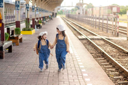 Two girls on a railway station, waiting for the trainの写真素材