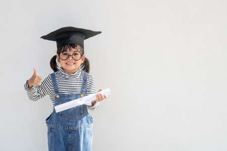 happy little girls with graduation conceptの写真素材