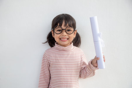 happy little girl with graduation conceptの写真素材