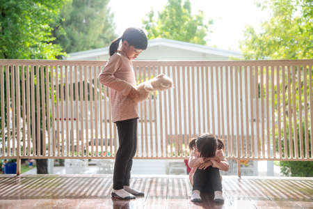 two little girl fighting over bearの写真素材