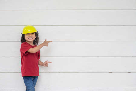 Asian girl children playing as an engineer helmet